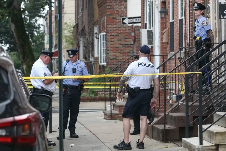 Police on the scene in the 1600 block of South 10th street, where two men were fatally shot by residents after allegedly breaking into the building.