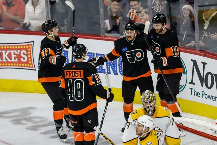 Flyers center Sean Couturier (right) celebrates his goal against the Predators at the Wells Fargo Center on Dec. 21.