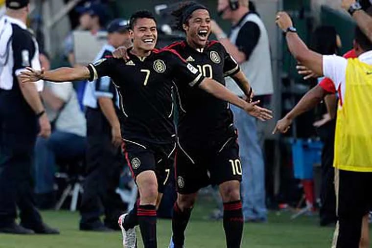 Mexico's Pablo Barrera, left, and Giovani Dos Santos celebrate Berrera's goal in the second half. (Jae C. Hong/AP)