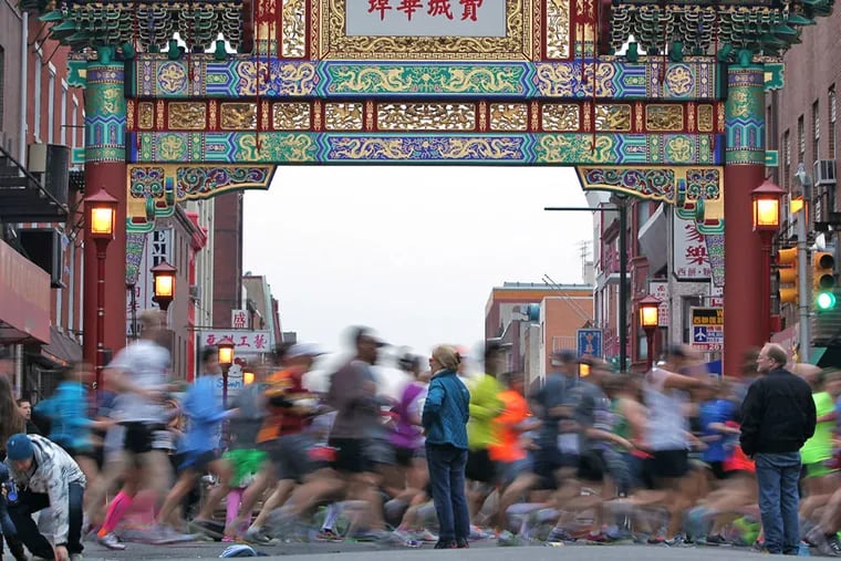 Runners pass the Arch in Chinatown during the Gore-Tex Philadelphia Marathon in Philadelphia on November 17, 2013.