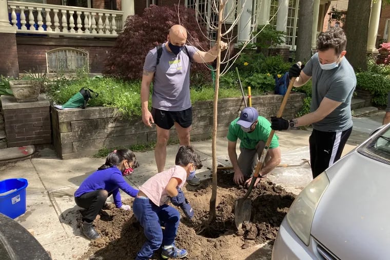 Action Tank volunteers and family members planting trees in the West Philly's Cedar Park neighborhood earlier this summer. Clockwise from top: Organization members Carlos Couto, Matt Connolly, and Jesse Hamilton, with Cuoto's son, Lucio, and daughter, Sabina.