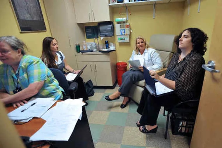 With integrated care at 11th Street Family Health Services, staff consult with one another about patients: (from left) Pat Dillon, social services manager; Jennifer Andia, nutrition health educator; Gail Partridge, family nurse practitioner, and Rebecca Vlam, adult behavioral health practitioner.