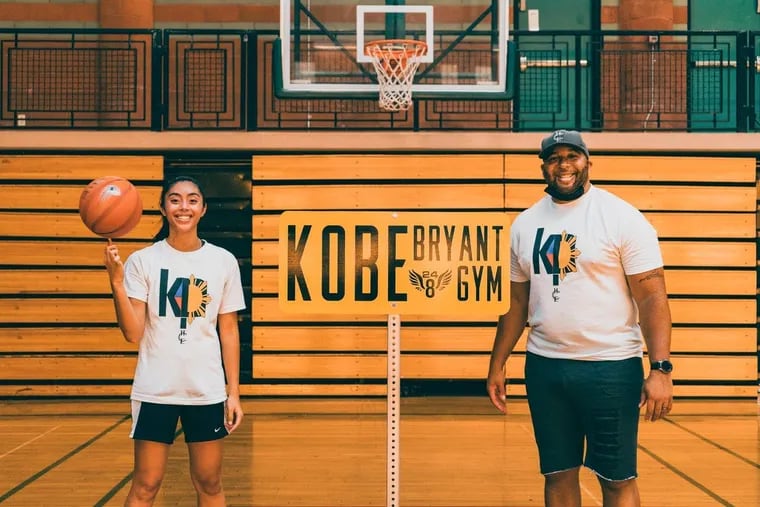Penn basketball player Kayla Padilla with Jared Lloyd modeling t-shirts with the logos designed by Padilla.