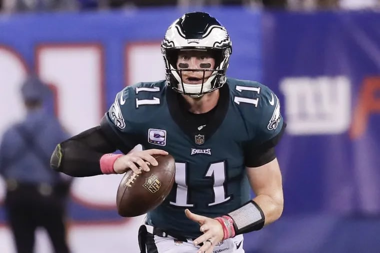 Eagles quarterback Carson Wentz scrambles with the football during the third-quarter against the New York Giants on Thursday, October 11, 2018 in East Rutherford, NJ. YONG KIM / Staff Photographer