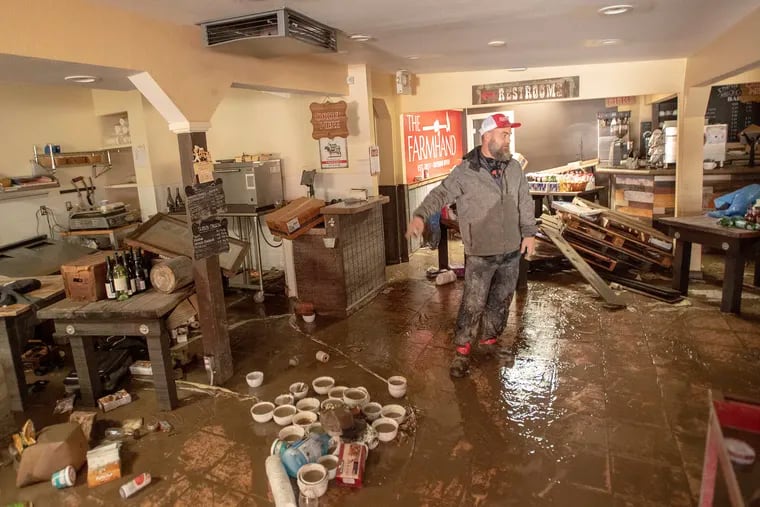 Farmhand Deli co-owner Jason Flint surveys the damage inside his restaurant along River Road as flood waters from the Russian River continue to recede in Guerneville, Calif., on Friday, March 1, 2019. Authorities have reopened the roads into two towns cut off for days by a rain-swollen river and residents and work crews have started cleaning up the muck that flooding left behind. (AP Photo/Josh Edelson)