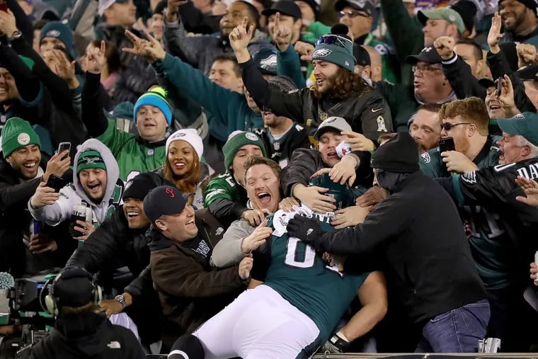 Eagles' fans celebrate as Stefen Wisniewski, jumps into the stands after Alshon Jeffery scores in the fourth quarter against the Vikings. Philadelphia Eagles win 38-7 over the Minnesota Vikings in the NFC Championship game in Philadelphia, PA on January 21, 2018.
