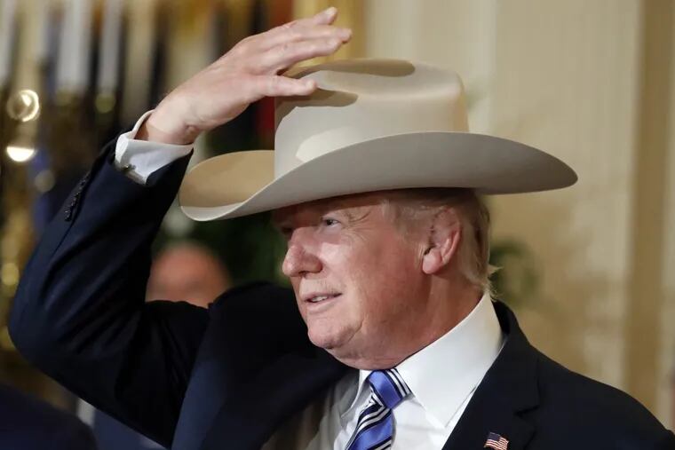 President Trump tries on a Stetson hat during a “Made in America” product showcase at the White House Monday.