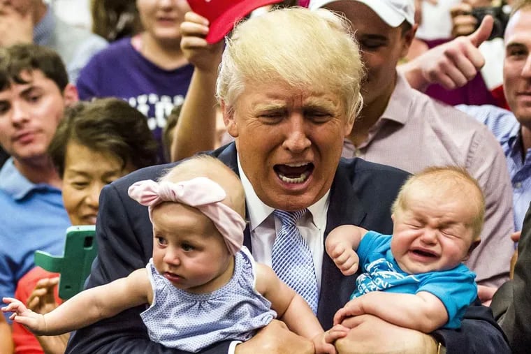 Donald Trump holds baby cousins Evelyn Kate Keane, 6 months, and Kellen Campbell, 3 months, during a campaign stop Friday in Colorado Springs, Colo.