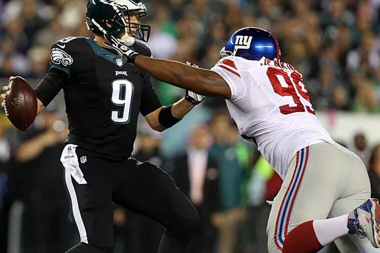 Nick Foles gets away from the Giants' Cullen Jenkins. (David Maialetti/Staff Photographer)