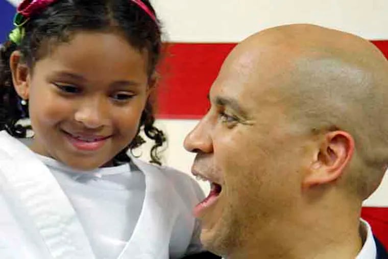 7 yr old Sophia Peragallo of Maple Shade (a self proclaimed Booker fan)  was picked up by Cory Booker during a meet and greet at the South Jersey Democrat HQ in Cherry Hill on July 17, 2013.   ( ELIZABETH ROBERTSON / Staff Photographer )