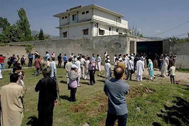 Media and local residents gather outside the house where al-Qaida leader Osama bin Laden was caught and killed in Abbottabad, Pakistan, on Tuesday, May 3. (AP Photo/Anjum Naveed)