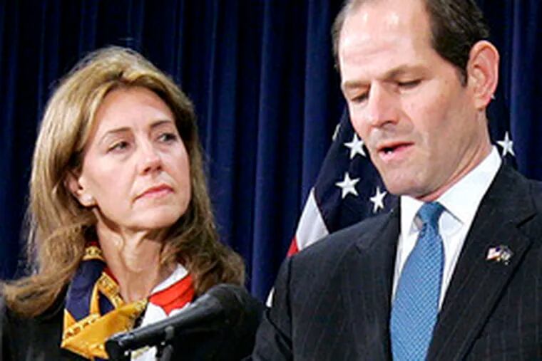 Eliot Spitzer announces his resignation as governorof New York. His wife, Silda, looks on.