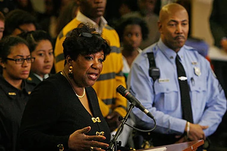 Superintendent Arlene Ackerman addresses the media gathered Friday at South Philadelphia High School. At right is newly assigned school police Sgt. Robert Samuels, who speaks fluent Cantonese and Mandarin and will help Chinese students communicate with school police. (Alejandro A. Alvarez / Staff Photographer)