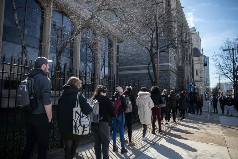 Students at Temple University line up outside of Mitten Hall for a free MMR vaccine following a mumps outbreak at the university on March 27. The outbreak sickened about 100 young people.
