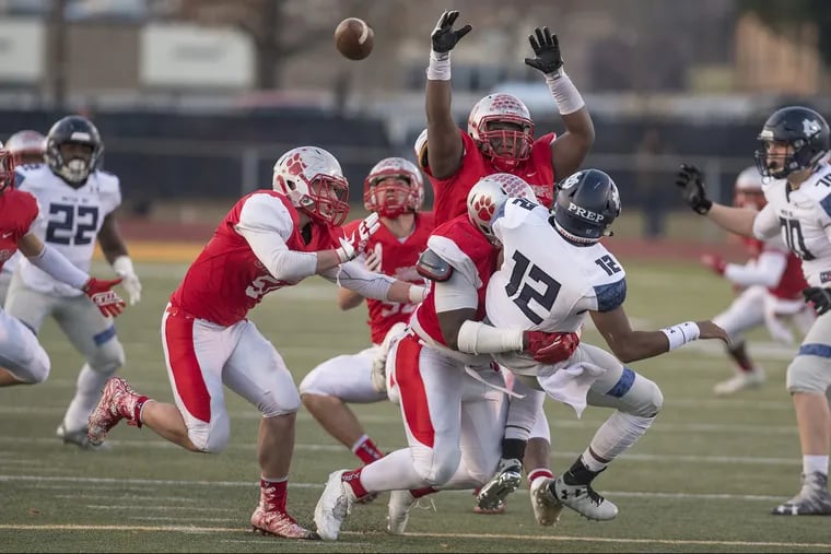 Mater Dei quarterback George Pearson barely get the pass off under pressure from St. Joseph defenders (from left) Bobby Hyndman, Wisdom Quarshie (arms up) and Sean Morris (hitting quarterback) in the NonPublic Group 2 championship game at Rowan University December 3, 2017. St. JosephÕs beat Mater Dei 30-14 for the title. CLEM MURRAY / Staff Photographer