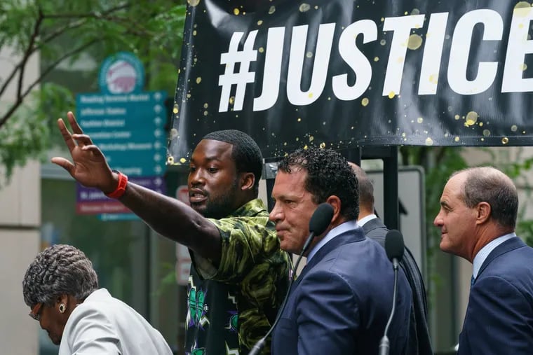 Meek Mill gestures at the crowd after exiting the criminal justice center, in Philadelphia, Tuesday August 27, 2019.