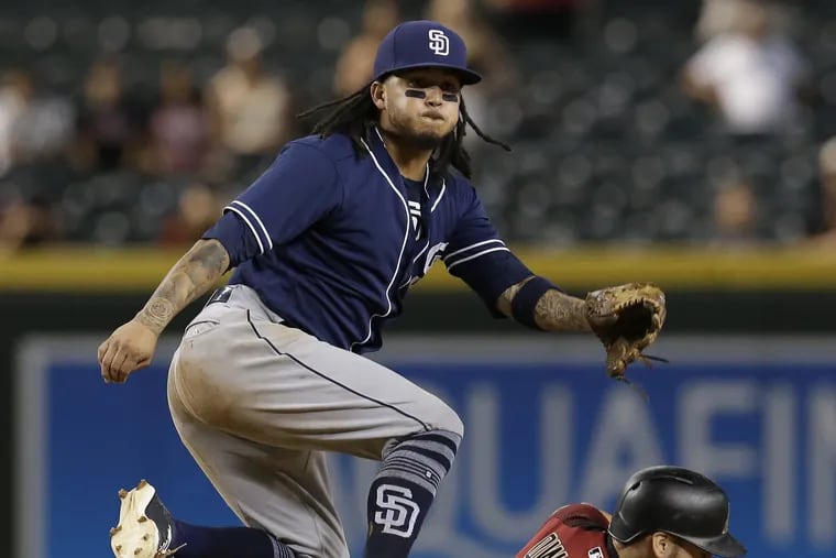 San Diego Padres shortstop Freddy Galvis turns the double play while avoiding Arizona Diamondbacks' Nick Ahmed (13) on a ball hit by Jon Jay in the 14th inning of a baseball game, Sunday, July 8, 2018, in Phoenix.