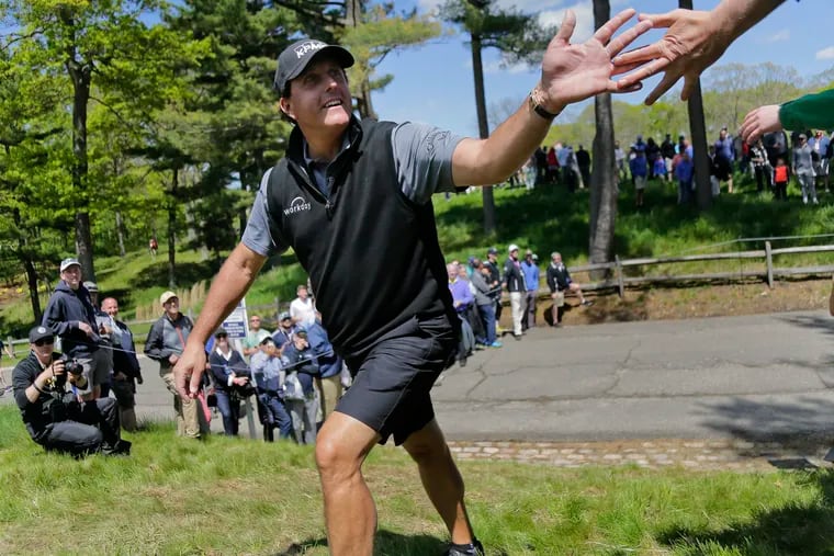 Phil Mickelson greets fans on his way to the 13th tee during a practice round for the PGA Championship golf tournament, Wednesday, May 15, 2019, at Bethpage Black in Farmingdale, N.Y. (AP Photo/Seth Wenig)