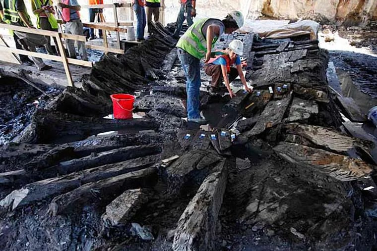 Archeologists dismantling the remains of an 18th-century ship at the World Trade Center site. Scientists say they have determined wood used in the ship's frame came from a Philadelphia-area forest about 1773.