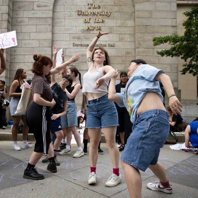 University of the Arts students Amanda “Dragon” Rattigan and Kayleigh Morrison, both in the class of 2025 dance during the protest outside of Hamilton Hall. The University of the Arts announced abruptly on May 31 that it would be closing.
