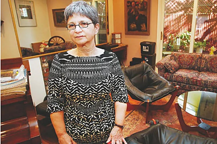 Judy Appelbaum stands in the living room of the home she might be forced to leave if the city's new tax valuation goes into effect. (Alejandro A. Alvarez/Staff)
