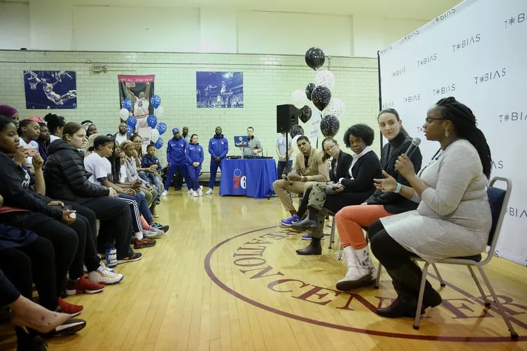 The Sixers' Tobias Harris, rear, moderates a panel of women professionals for middle-school girls at the Shepard Recreation Center in West Philadelphia on Thursday, March 21, 2019. The women (from rear) are NBC Sports Philadelphia reporter Serena Winters, writer and editor Maya Francis, Sixers data scientist Ivana Seric, and Philly Startup Leaders executive director Kiera Smalls. Philly Startup Leaders is one of many groups that help entrepreneurs in the area.