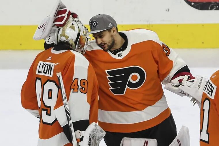 Flyers’ new goalie Petr Mrazek celebrates with goalie Alex Lyon after beating the Canadiens in overtime 3-2 at the Wells Fargo Center on February 20.