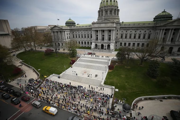 Protesters gather outside the state Capitol in Harrisburg on Monday, calling for Gov. Wolf to reopen Pennsylvania's economy.