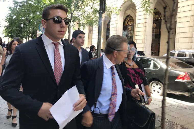 Ari Goldstein, left, former president of Temple University's Alpha Epsilon Pi fraternity, leaves the Criminal Justice Center after a preliminary hearing on July 19, 2018.