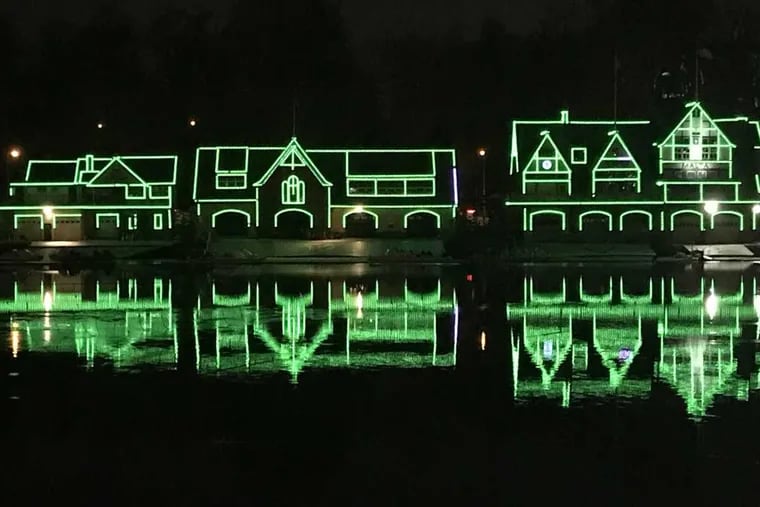 Boathouses on the Schuylkill show green in support of the Philadelphia Eagles on Friday night, January 19, 2018.