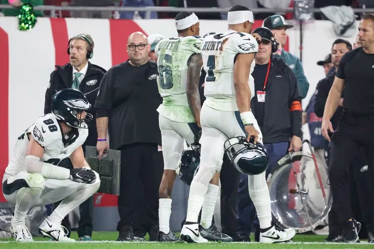 Eagles quarterback Jalen Hurts and wide receiver DeVonta Smith walk off the field after intentional grounding was called on Hurts in the third quarter.