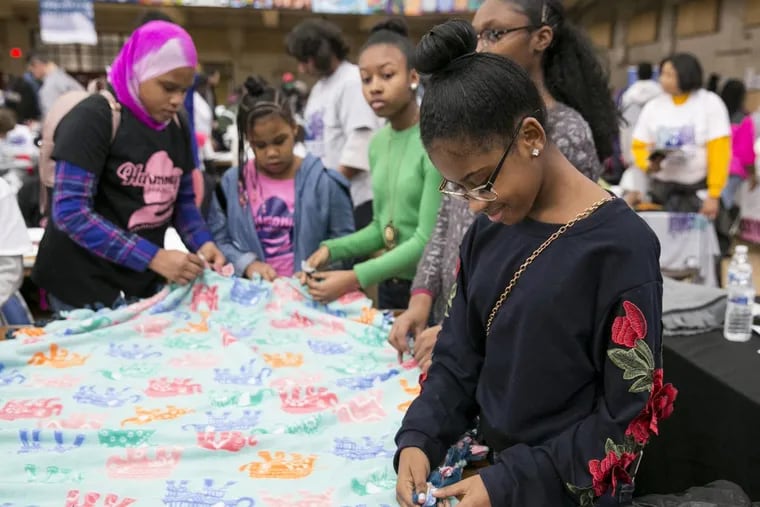 Ajia Johns, front right, makes a knot blanket during the MLK Day of Service at Girard College, in Philadelphia, Monday, Jan. 15, 2018. JESSICA GRIFFIN / Staff Photographer
