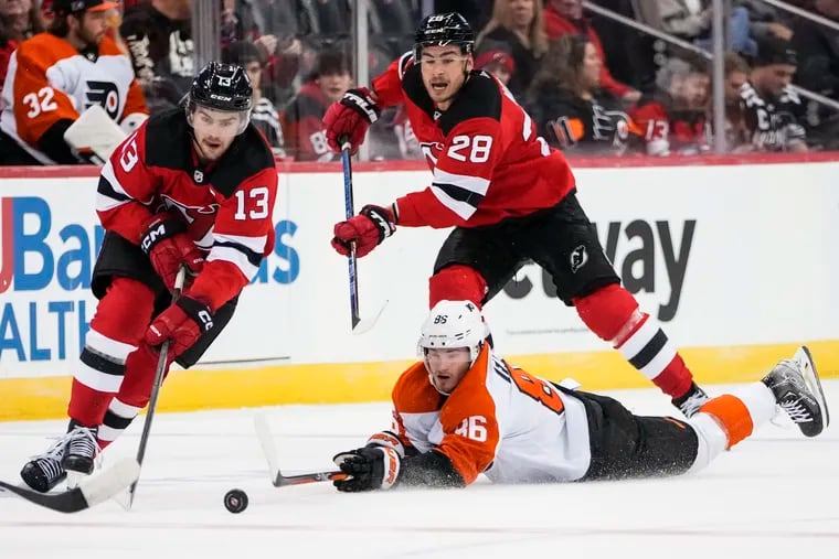 New Jersey Devils' Nico Hischier (13) drives past Philadelphia Flyers' Joel Farabee (86) as Timo Meier (28) watches during the second period a preseason NHL hockey game, Monday, Sept. 25, 2023, in Newark, N.J.