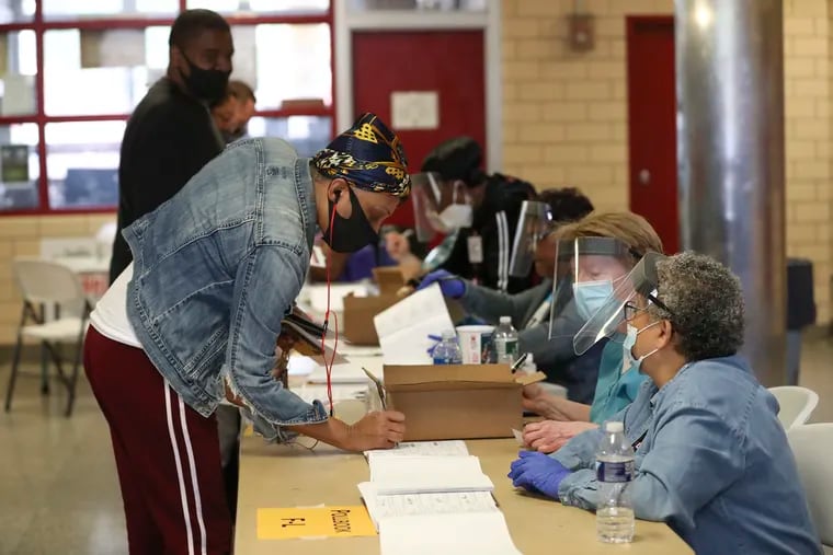 Voters sign in at the Marian Anderson Recreation Center on Election Day in Philadelphia on Tuesday, June 2, 2020.