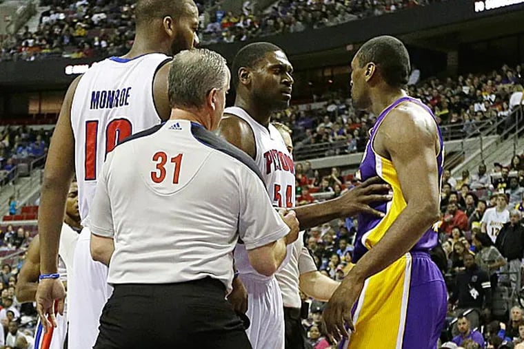 On Sunday, Lakers forward Metta World Peace received a flagrant foul after mixing it up with Pistons guard Brandon Knight. (Carlos Osorio/AP)