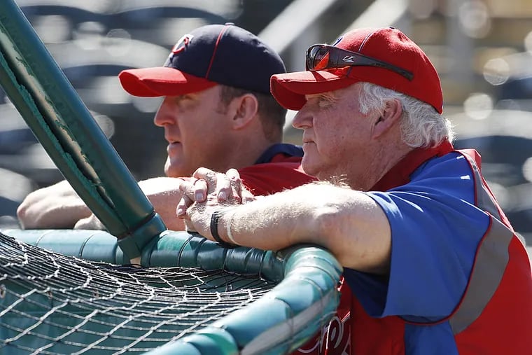 Charlie Manuel, right, watches batting practice alongside Jim Thome.