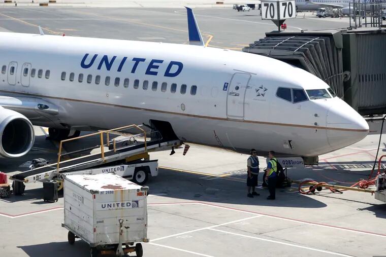 FILE - In this July 18, 2018, file photo a United Airlines commercial jet sits at a gate at Terminal C of Newark Liberty International Airport in Newark, N.J. United Continental Holdings, Inc. reports financial results Tuesday, April 16, 2019. (AP Photo/Julio Cortez, File)