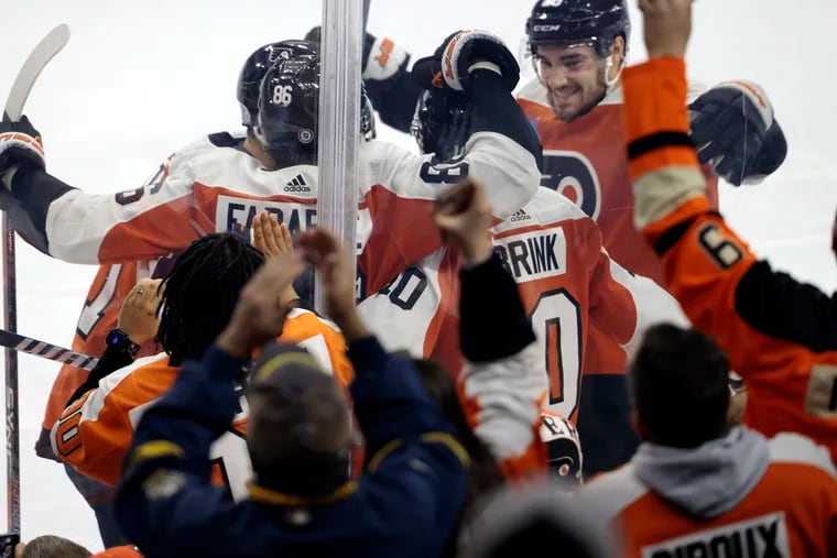 Flyers players celebrate Bobby Brink's second-period goal against the Columbus Blue Jackets on Sunday night.