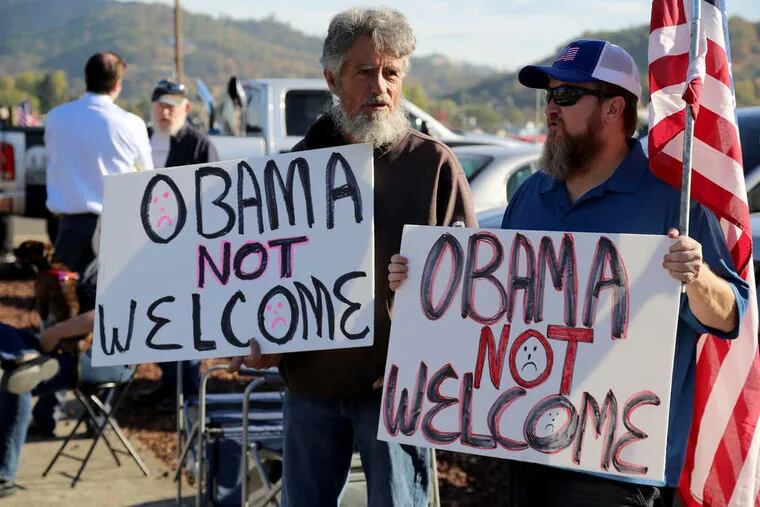 Gun-rights activists and others were out in force Friday in Roseburg, Ore., awaiting the arrival of President Obama. He was in town to meet with victims' families after the killings at Umpqua Community College.