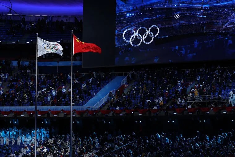 The Olympic (left) and Chinese (right) flags flying next to each other during the Opening Ceremony of the Winter Olympics in Beijing on Feb. 4.