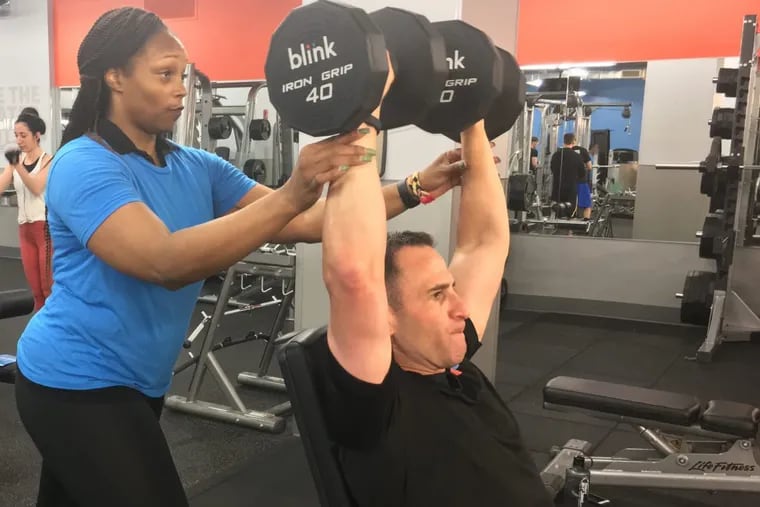 Blink President Todd Magazine with his trainer at a recent workout. He said studio gyms are popular because people want a healthier lifestyle.