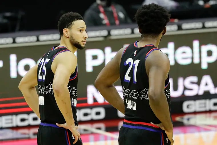 Sixers guard Ben Simmons looks over at teammate center Joel Embiid during a break against the Brooklyn Nets on Saturday, February 6, 2021 in Philadelphia.