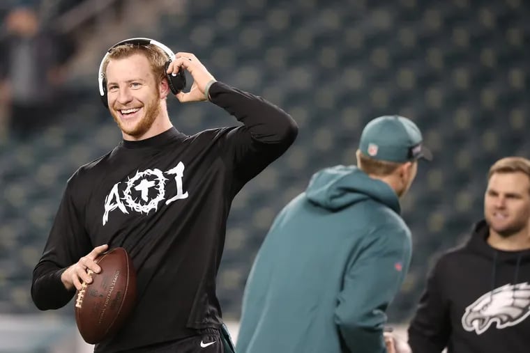 The Eagles' Carson Wentz laughs as he warms up before the Philadelphia Eagles play the Washington Redskins in Philadelphia, Pa., on December 3, 2018.