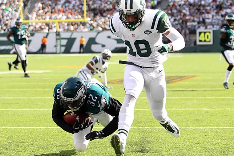 Philadelphia Eagles defensive back Eric Rowe (32) intercepts a pass intended for New York Jets wide receiver Devin Smith (19) and rolls into the end zone for a touchback during the third quarter at MetLife Stadium.