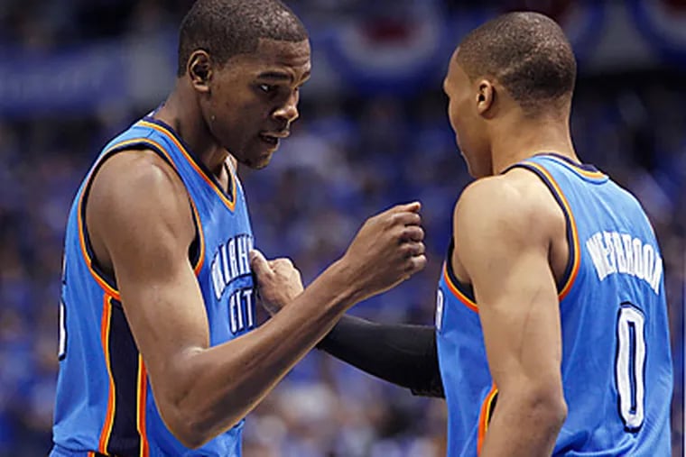 Thunder forward Kevin Durant, left, and guard Russell Westbrook react to play during the first half. (AP Photo/Eric Gay)