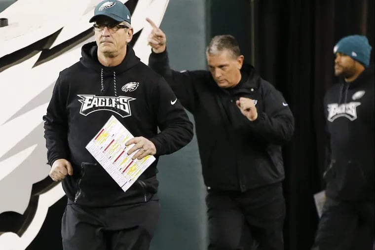 Eagles offensive coordinator Frank Reich runs on the field with defensive coordinator Jim Schwartz before the Eagles played the Minnesota Vikings in the NFC Championship game on Sunday, January 21, 2018 in Philadelphia. YONG KIM / Staff Photographer