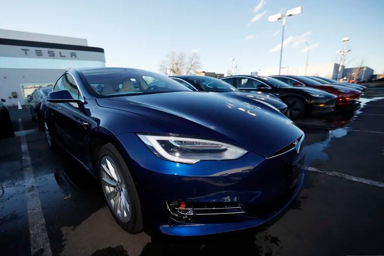 FILE - In this Sunday, Feb. 3, 2019, file photograph, an unsold 2019 S75D sits at a Tesla dealership in Littleton, Colo. Tesla's assembly lines slowed down during a rocky start to the new year, which will likely magnify nagging doubts about whether the electric car pioneer will be able to make the leap into mass market.