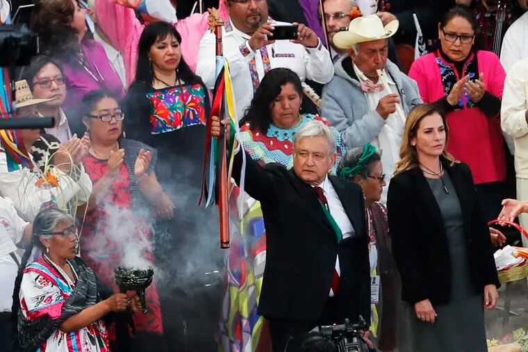 Mexico's new President Andres Manuel Lopez Obrador, center, participates in a traditional indigenous ceremony at the Zocalo, in Mexico City, Saturday, Dec. 1, 2018. Mexicans are getting more than just a new president Saturday. The inauguration of Lopez Obrador will mark a turning point in one of the world's most radical experiments in opening markets and privatization(AP Photo/Marco Ugarte)