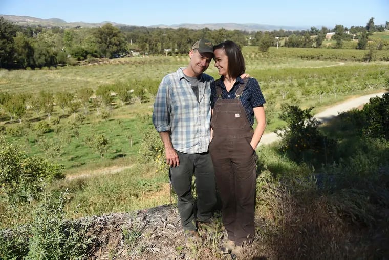 This April 17, 2019 photo shows John Chester, left, and his wife Molly, of the documentary film "The Biggest Little Farm," at Apricot Lane Farms in Moorpark, Calif. (Photo by Chris Pizzello/Invision/AP)