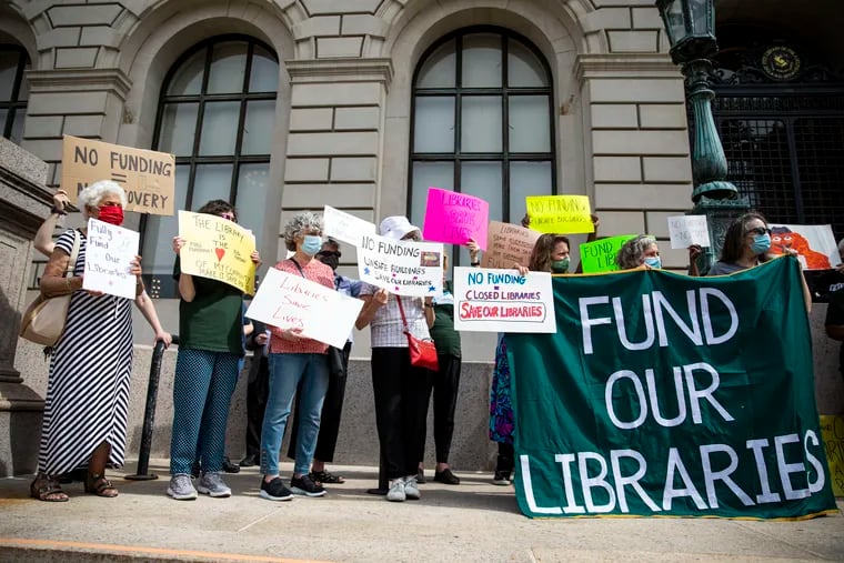 Members of the Friends of the Free Library of Philadelphia, library workers, and community supporters rally in front of the Parkway Central Library on June 2 to call for more funding for the system.